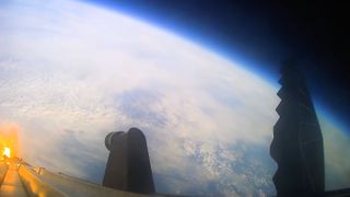 View of Earth's curve against the blackness of space captured from a camera on SpaceX's Starship rocket.
