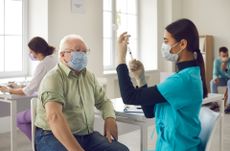 An older man being vaccinated.