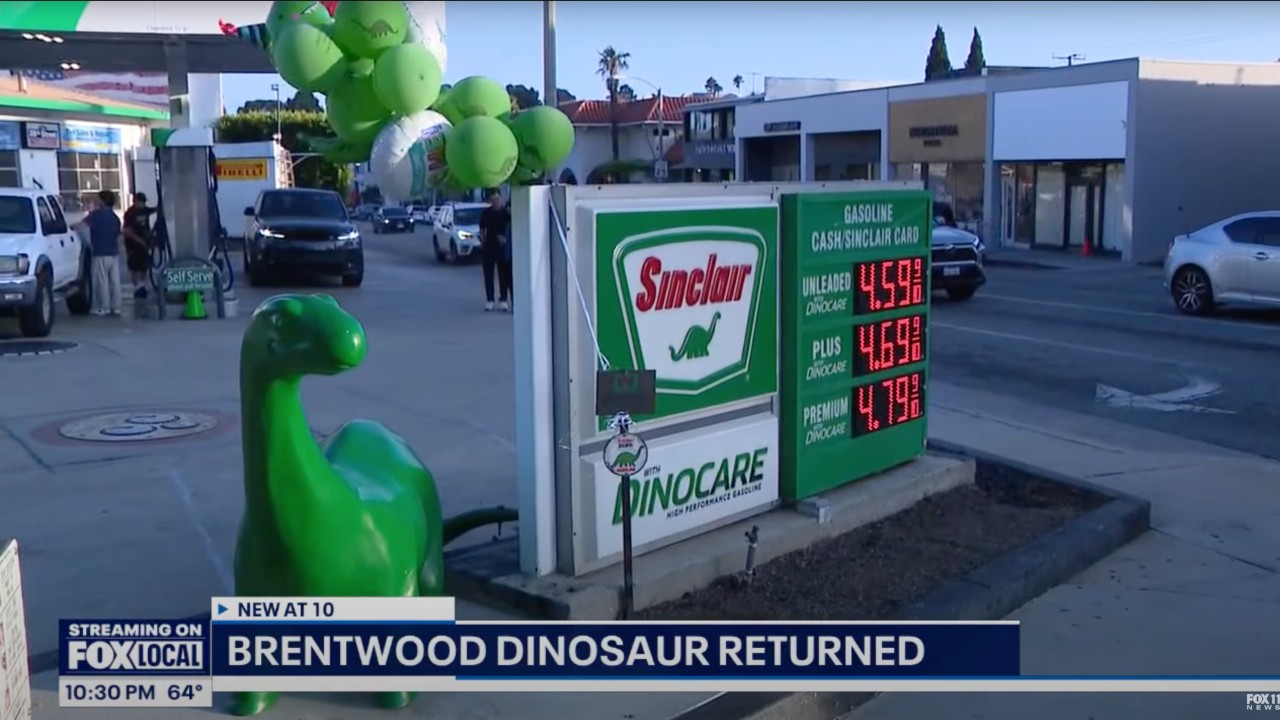 Shot of Brentwood, California&#039;s Sinclair gas station with the returned Claire the dinosaur in the foreground.