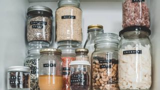 Multiple food jars sitting in a pantry