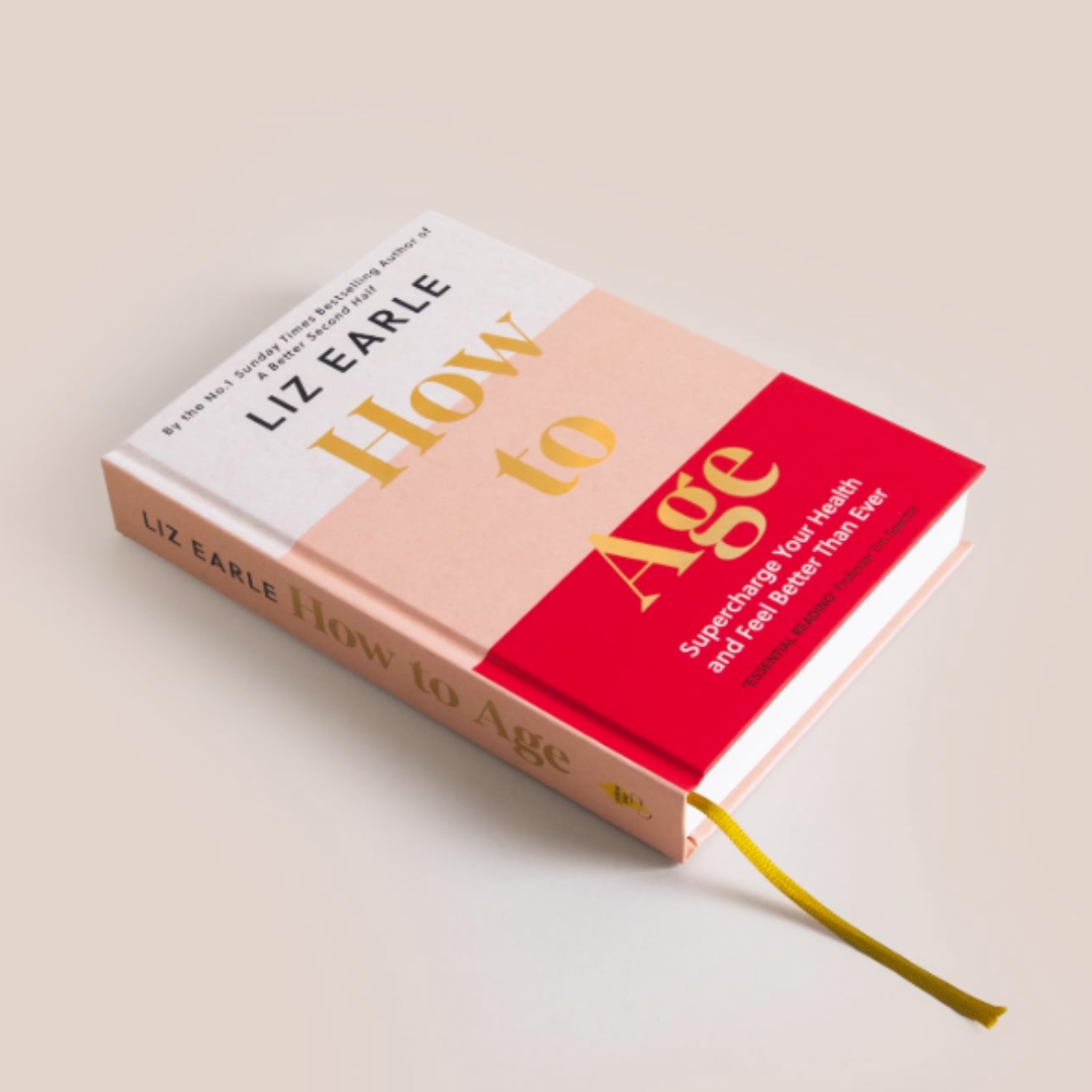 A product shot of Liz Earle's new book How To Age, on a pink background