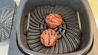 Ninja Foodi Health Grill & Air Fryer with grilled burger patty inside