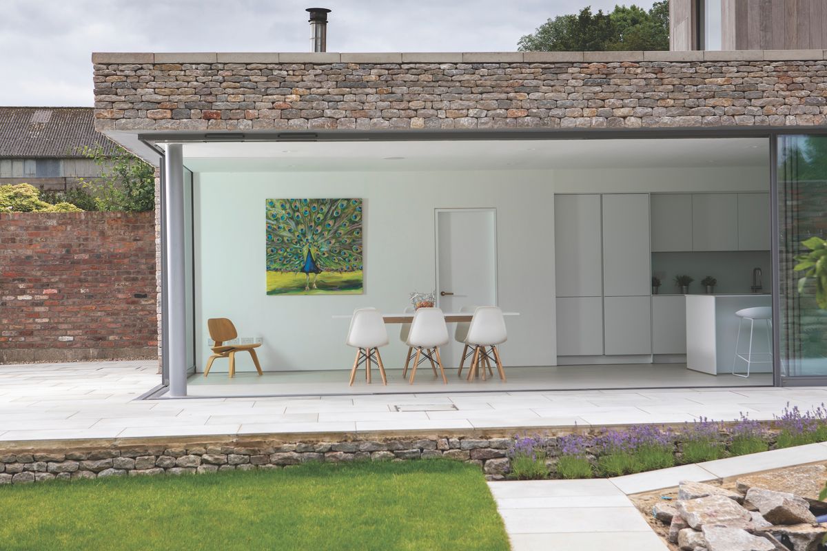 The new contemporary form is clad in traditional dry stone walling frequently found in the local area.