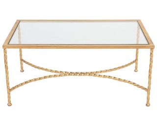 A gold coffee table with glass top and rope detail