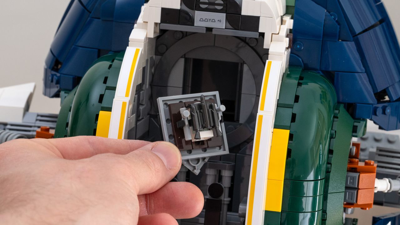 Lego Star Wars UCS Jango Fett&rsquo;s Firespray-Class Starship (75409) cockpit with canopy open and hidden gear compartment being removed by hand