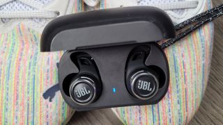 the jbl reflect flow pro in their charging case
