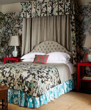 Bed with coronet and patterned wallpaper and bedding in a bedroom