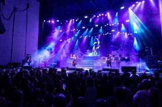 Martin Professional lights shine down on the band Halestrom in blue and purple hues on tour.