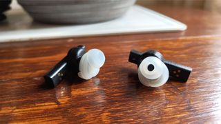 Final ZE8000 MK2 in-ear headphones with ear-tips fitted on wooden surface