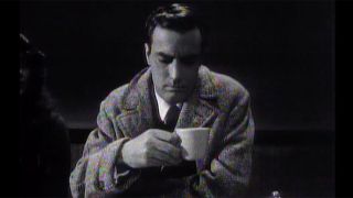 Peter Aykroyd drinking coffee in the black and white SNL sketch The Java Junkie.