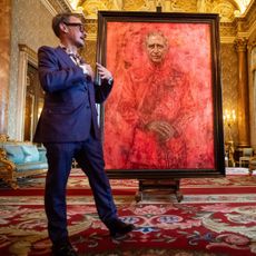 Artist Jonathan Yeo and King Charles III stand in front of the portrait of the King Charles III by artist Jonathan Yeo as it is unveiled in the blue drawing room at Buckingham Palace on May 14, 2024 in London, England. 