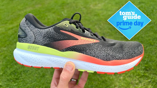 a hand holding the Brooks Ghost 16