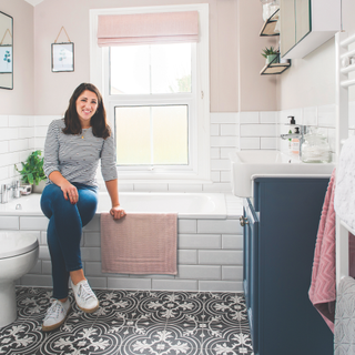 a pink bathroom with victorian tiled floor