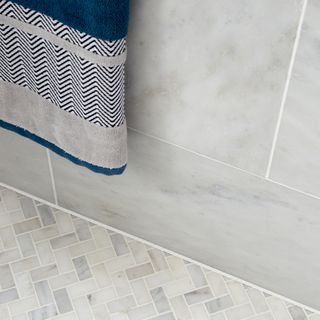 bathroom wall and floor tiles with towel