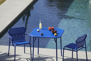 colourful garden furniture ideas: blue bistro set by pool from nest