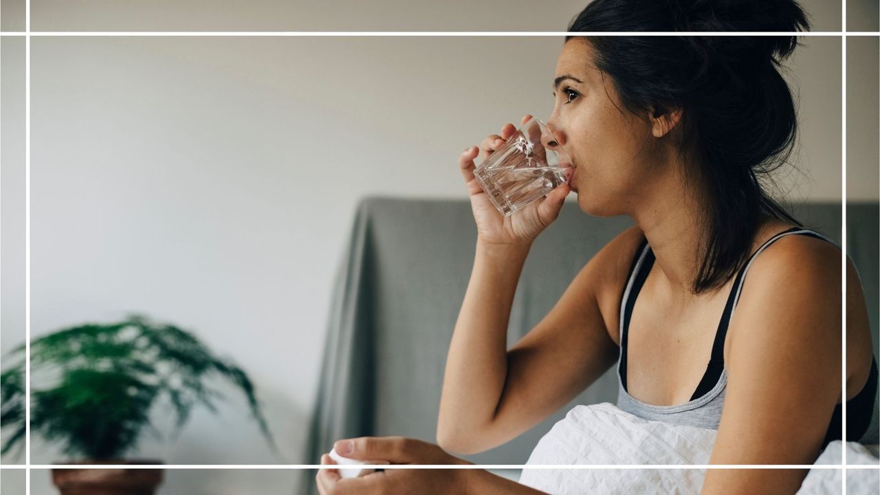 When does morning sickness start illustrated by a woman sat in bed drinking water