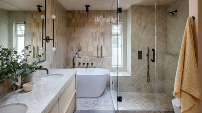 Warm neutral bathroom with beige tiles and wooden details