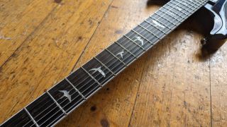 The neck of a PRS SE Mark Holcomb SVN with bird inlays