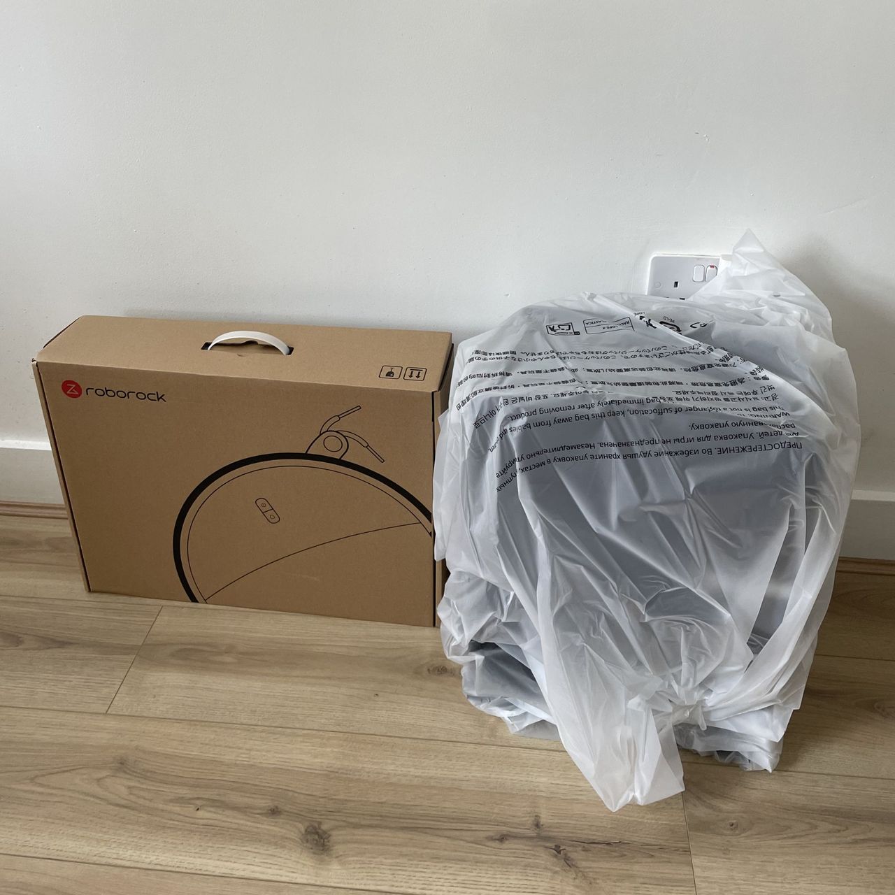 Roborock Saros 20 Robot Vacuum box and wrapping sitting on wood-effect flooring
