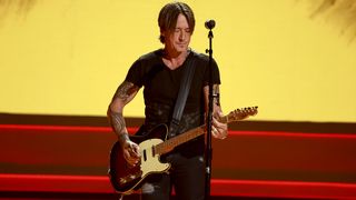 In this image released on September 18, 2024, Keith Urban performs onstage during the 17th Academy Of Country Music Honors at Ryman Auditorium on August 21, 2024 in Nashville, Tennessee