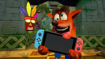 A photo illustration of Crash Bandicoot holding a Nintendo Switch.