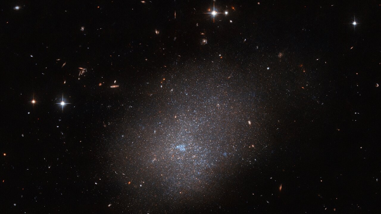 Hubble Space Telescope captures 'ghostly' glow of distant galaxy