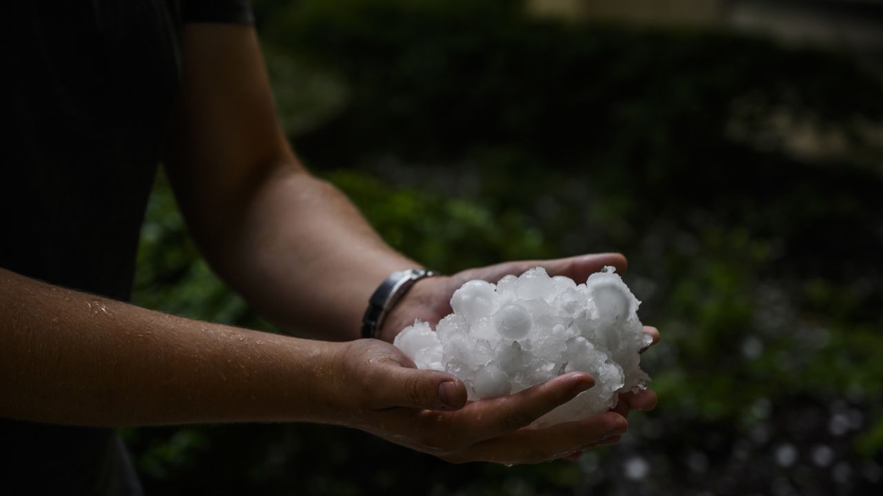 man holds hail stones