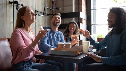 people eating pizza at a restaurant