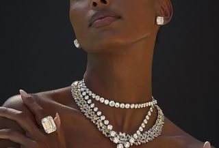 Model Jasmine Tookes wearing diamond earrings, bracelets, and rings.