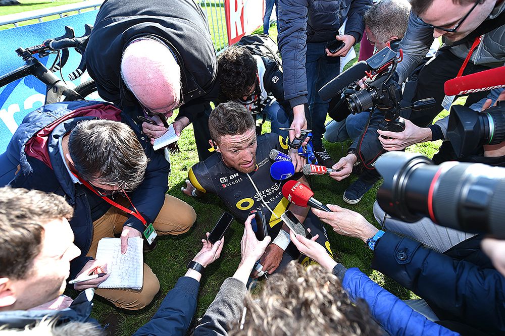 Adrien Petit is swamped by media as the best French finisher in tenth place