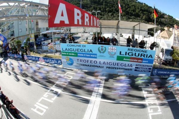 The peloton flashes past the finish area