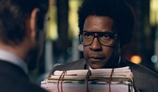 Roman J. Israel Esq. Denzel Washington stands with a bunch of rubber banded files