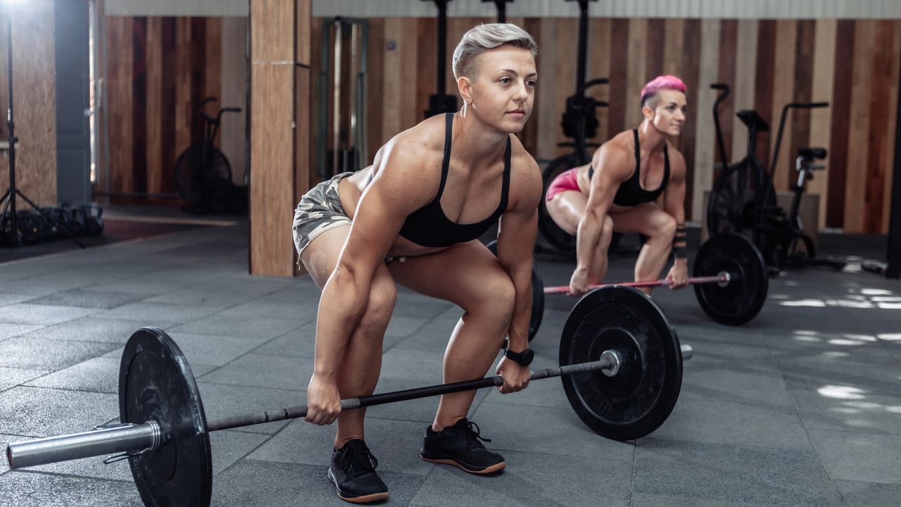 Women doing barbell deadlift