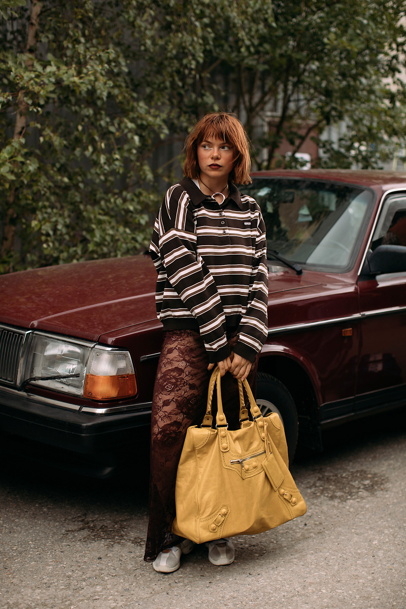 Woman in striped polo and lace skirt
