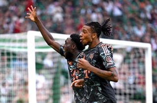 Michael Olise of Bayern Munich celebrates with Alphonso Davies after scoring his team's fourth goal during the Bundesliga match between SV Werder Bremen and FC Bayern München at Weserstadion on September 21, 2024 in Bremen, Germany.