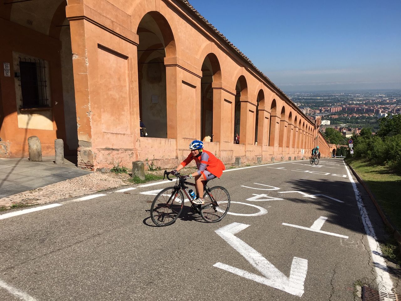 A rider fights against gravity on the climb to San Luca