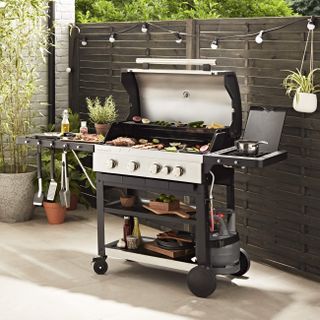 A gas barbecue on an outside courtyard