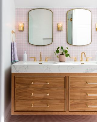 A bathroom with matching mirrors and sink