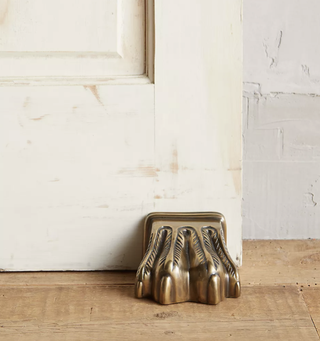Antique brass claw shaped doorstop from Anthropologie.