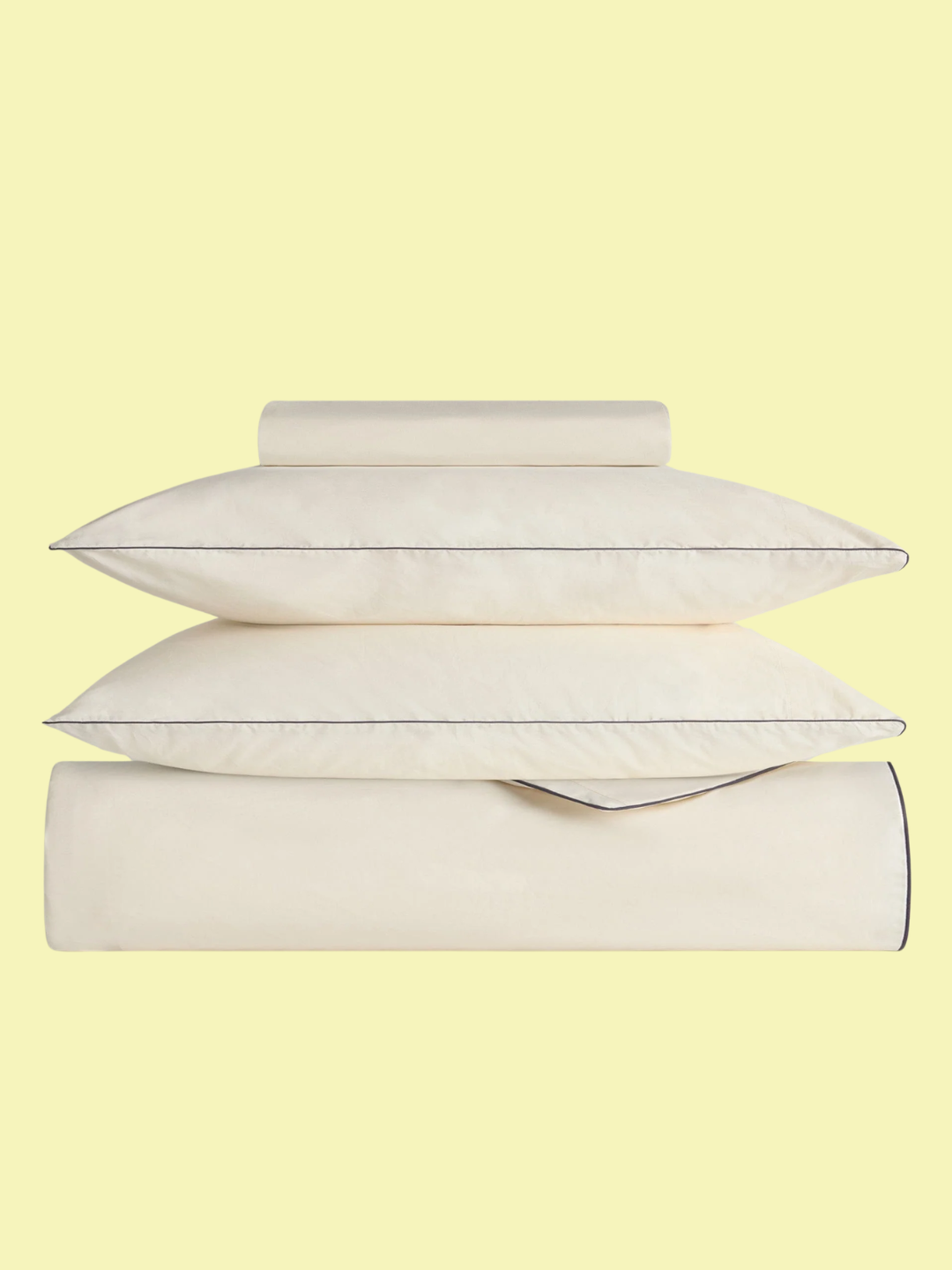 A crisp and cool bedding set from Rise &amp;amp; Fall in buttermilk with navy piping
