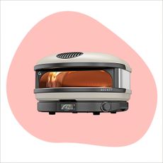 Three of the best pizza ovens on a pink and blue background in the style of Ideal Home