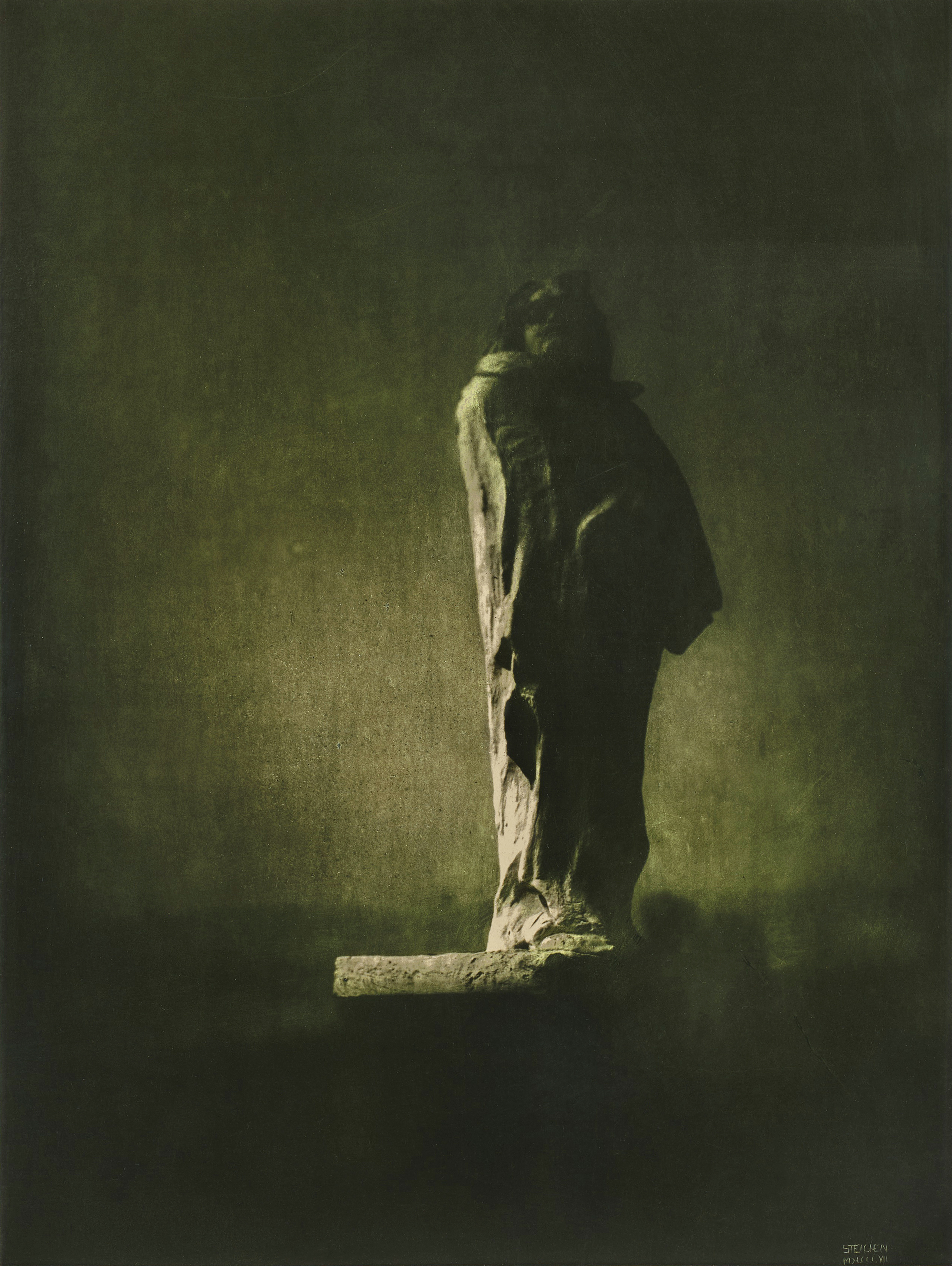 A haunting, pictorialist photograph of Rodin's monumental statue of Honor&eacute; de Balzac, shrouded in deep shadows and bathed in a dim, eerie greenish light under a night sky.