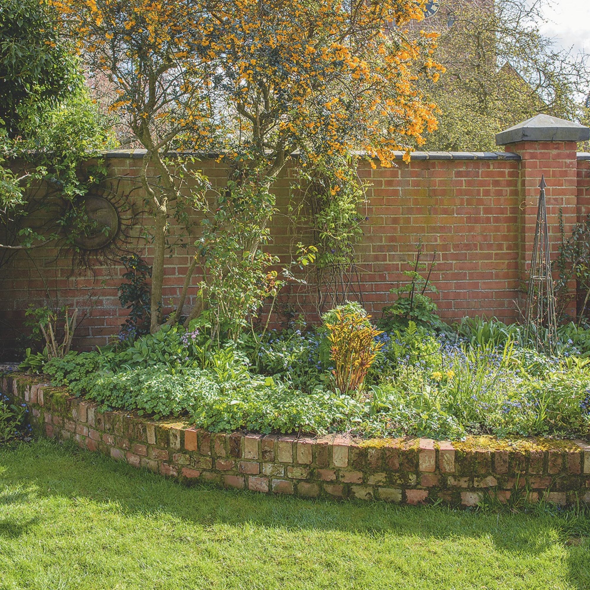 Brick garden edging between border and lawn in garden