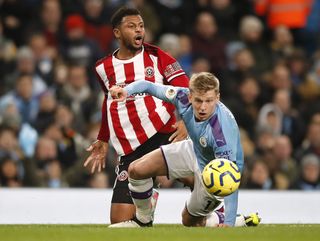 Sheffield United’s Lys Mousset, left, and Manchester City’s Kevin De Bruyne battle for the ball