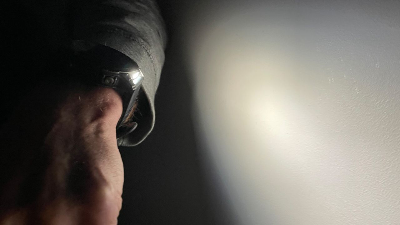 A model wearing the garmin fenix pro solar watch with the flashlight switched on