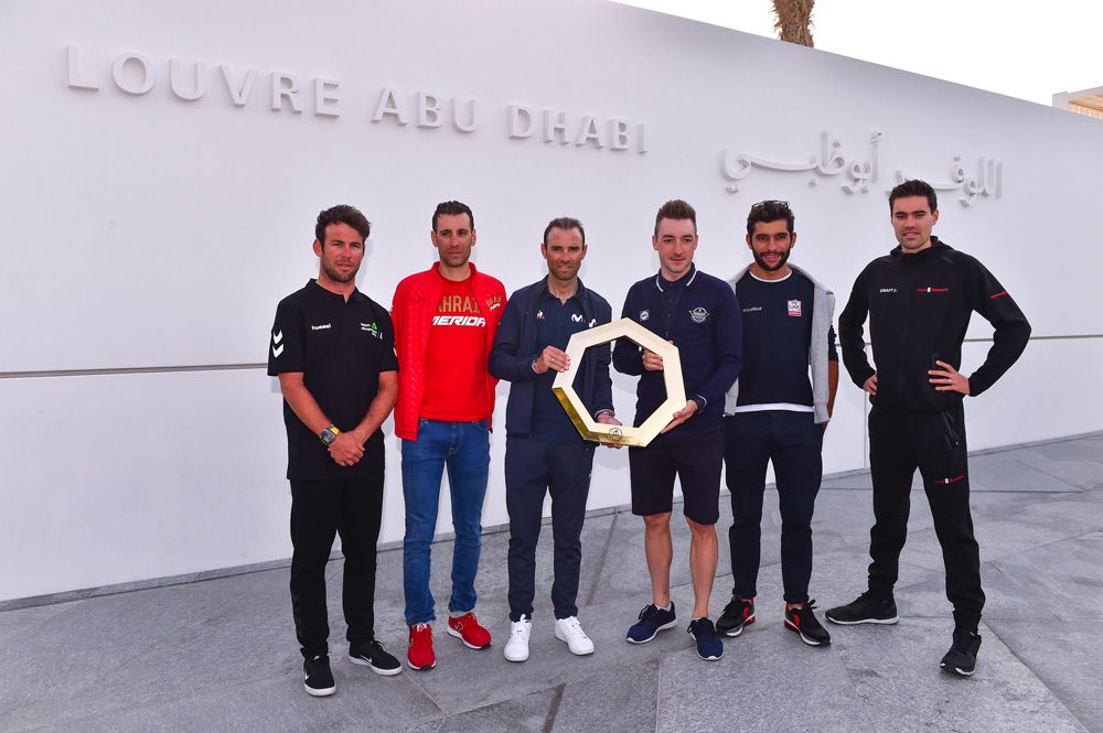 The riders pose outside the Abu Dhabi Louvre with the UAE Tour trophy