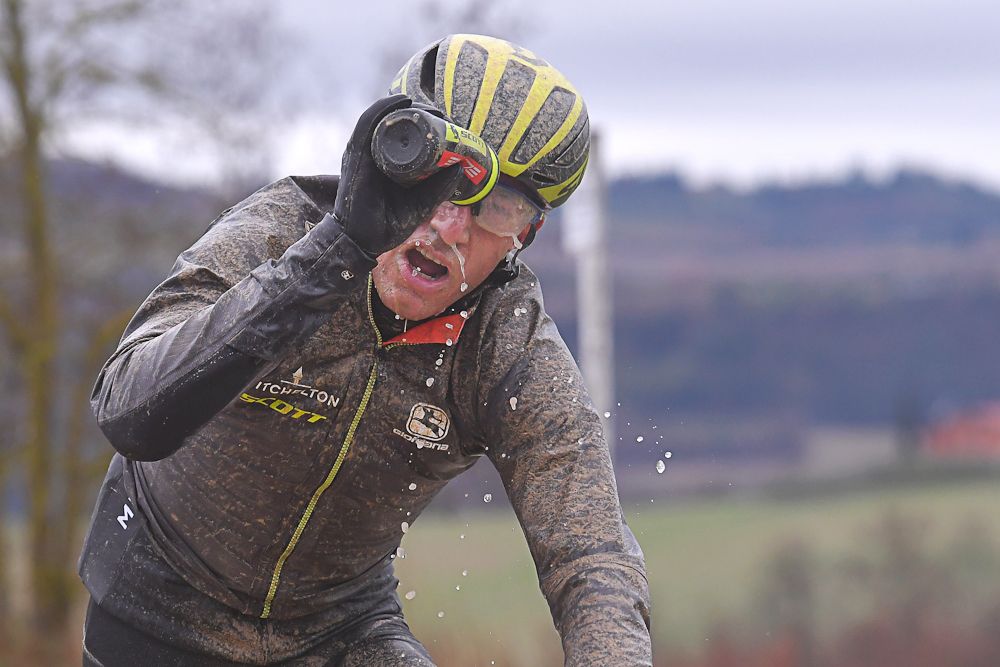 Robert Power cleans off after a gravel section at Strade Bianche