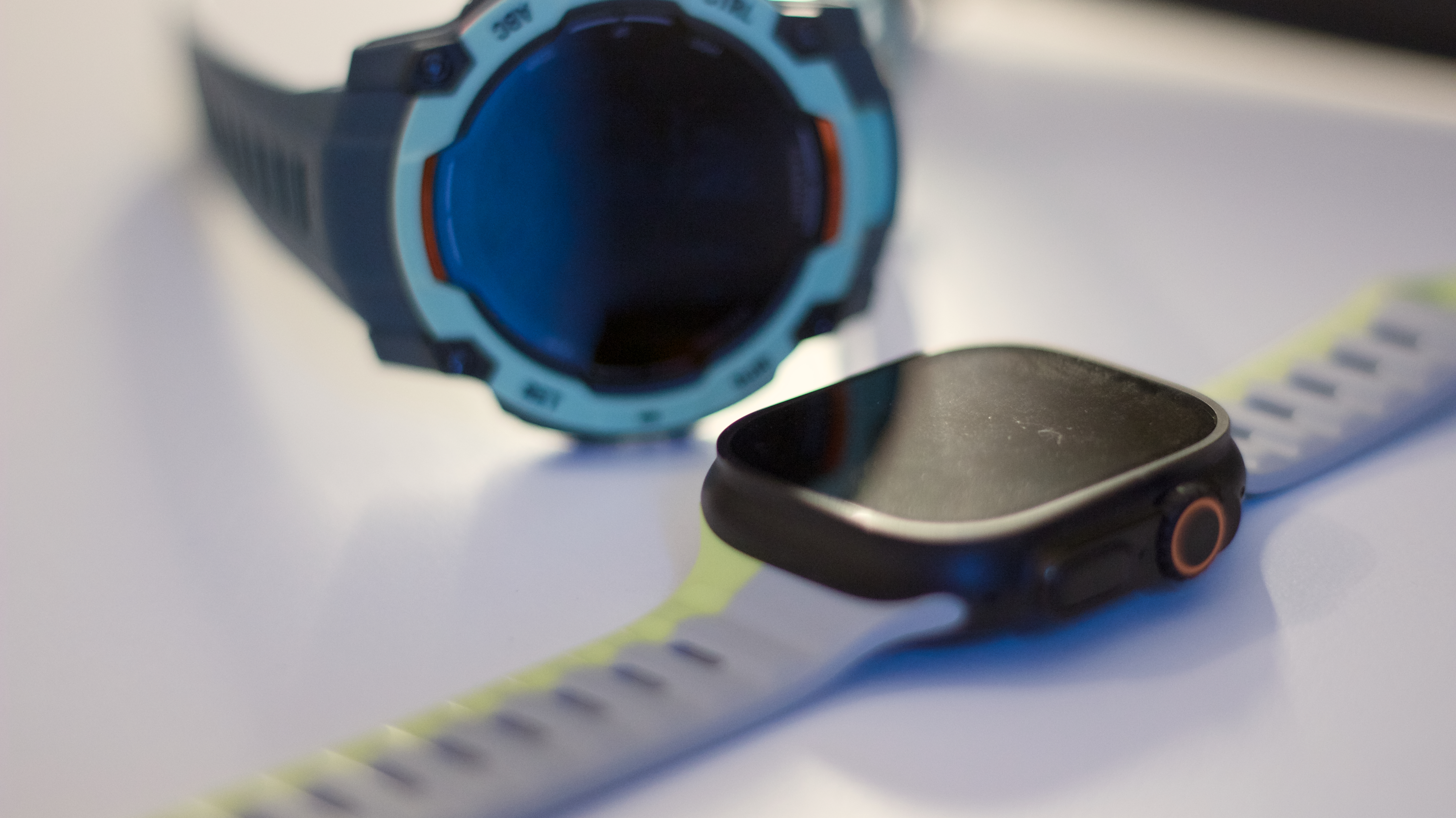 Garmin Instinct 3 next to the Apple Watch Ultra 2