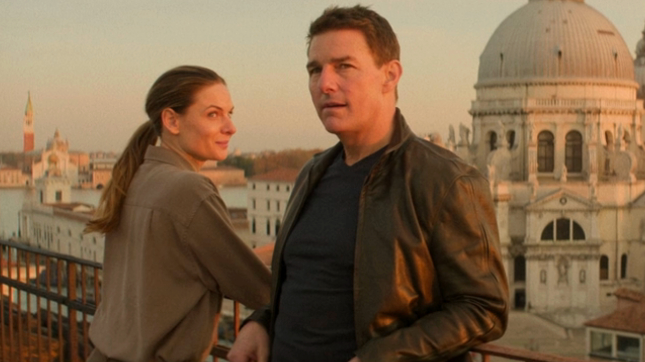 Rebecca Ferguson smiles standing next to Tom Cruise on a balcony in Venice in Mission: Impossible - Dead Reckoning.