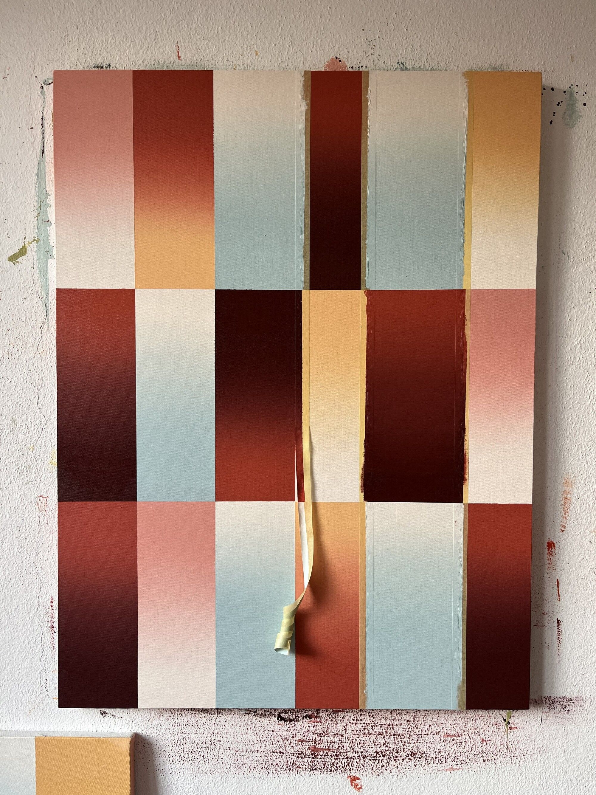 Image of a canvas with different gradient rectangles on it and the painters tape peeling off.